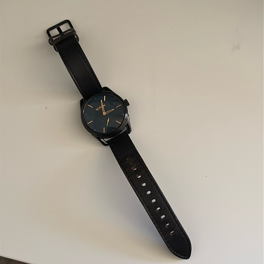 Black and gold Nixon C39 leather watch